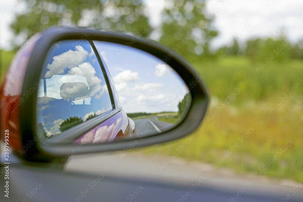 car view in the side rearview mirror