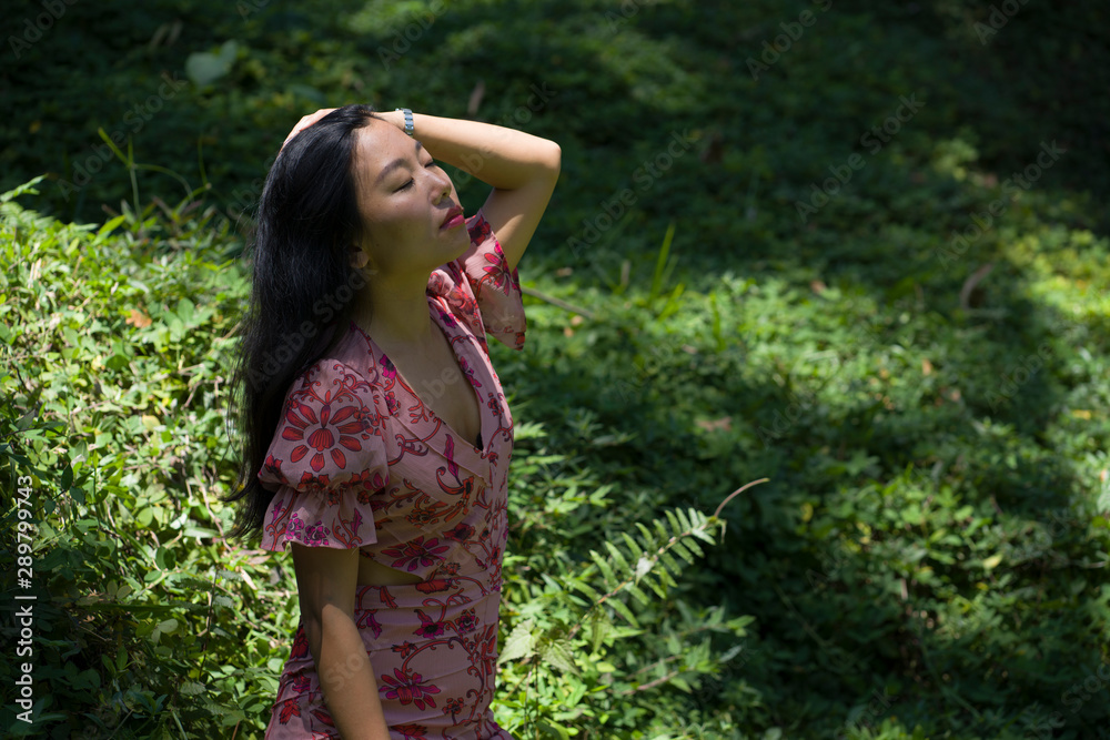 young beautiful and happy Asian Chinese woman in stylish dress enjoying adventure holiday trip exploring nature at tropical island jungle feeling fresh and relaxed young beautiful and happy Asian Chinese woman in stylish dress enjoying adventure holiday trip exploring nature at tropical island jungle feeling fresh and relaxed