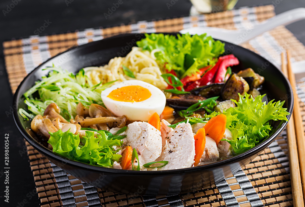 Japanese ramen soup with chicken, egg, shimeji mushrooms and eggplants on dark wooden background. Chanko nabe, sumo soup. Japanese ramen soup with chicken, egg, shimeji mushrooms and eggplants on dark wooden background. Chanko nabe, sumo soup.