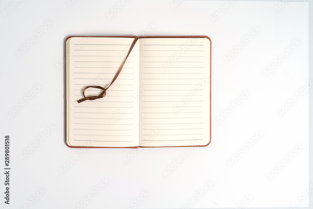 top view blank orange leather diary on white desk top view blank orange leather diary on white desk