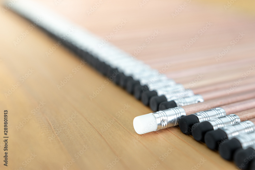 Wooden pencils with black eraser place on Wood background And Close Up , One pencil singled out