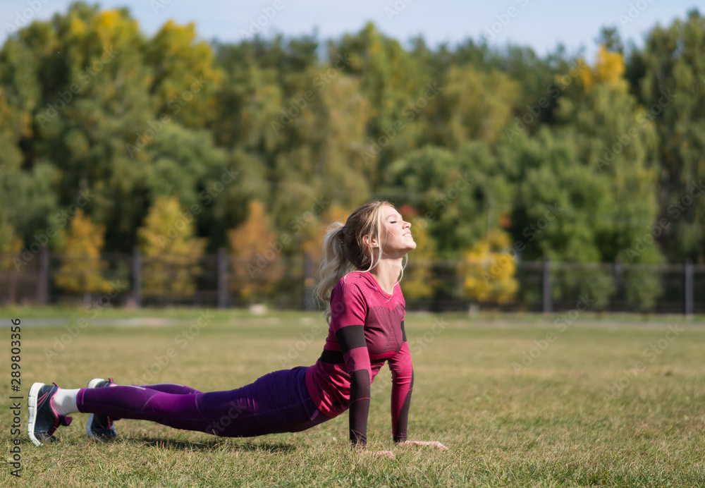 Woman doing yoga exercises in summer time Woman doing yoga exercises in summer time