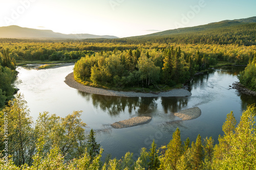 A shallow river in the green hills of Jamtland, Sweden.