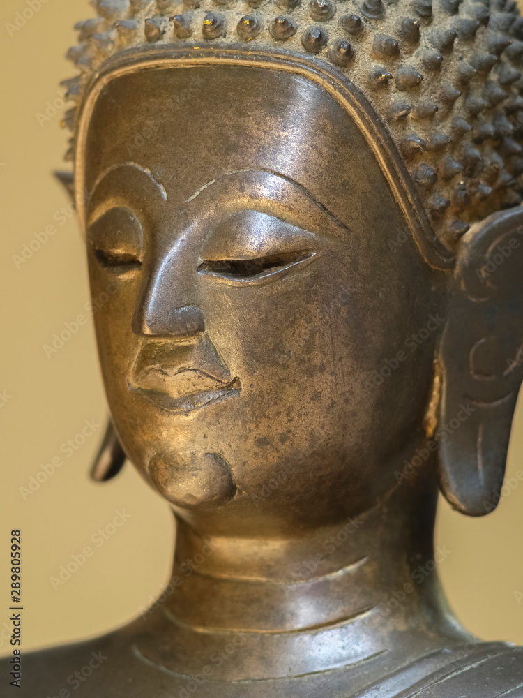 Close-up side face of bronze buddha statue, Lan Xang Style Art 17th Century.