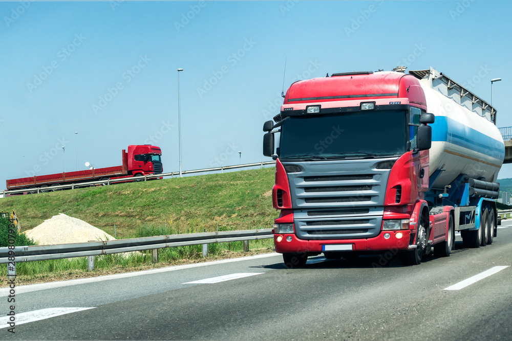 Truck on summer country highway under blue sky