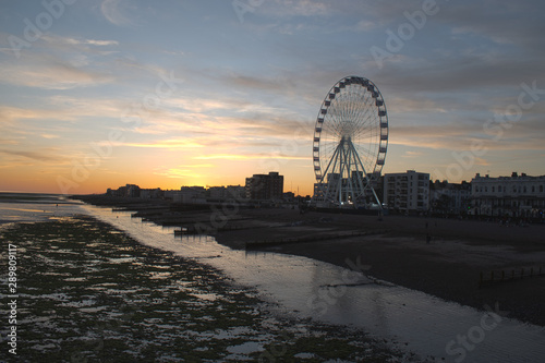 Sunset Worthing England Seafront at low tide with the Observation Wheel in action on beautiful September evening. © Geoff
