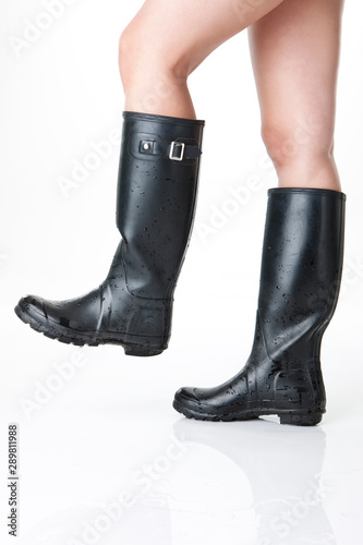 Image of a woman's legs wearing rubber boots.
