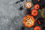 Table top view aerial image of decoration Happy Halloween day background concept.Flat lay accessories essential object to party athe pumpkin & sweet candy on rustic stone.Space for creative design.