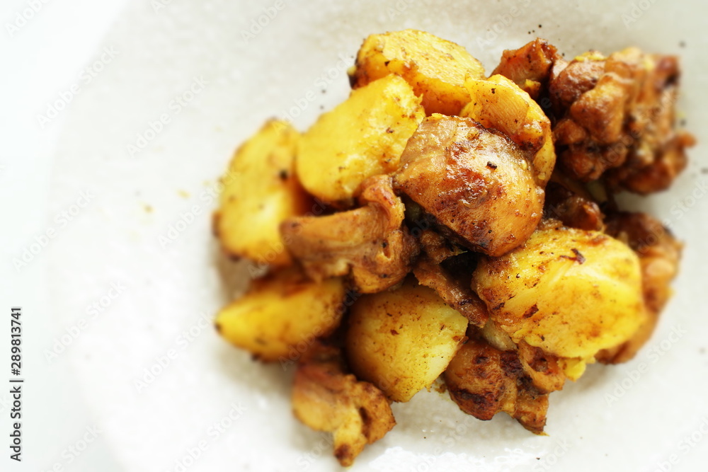 Potato and chicken stir fried with curry Potato and chicken stir fried with curry