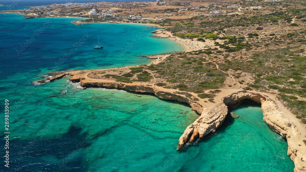 Aerial drone photo of paradise rocky seascape forming caves with turquoise clear sea near popular beaches of Pori and Italida, Koufonisi island, Cyclades, Greece