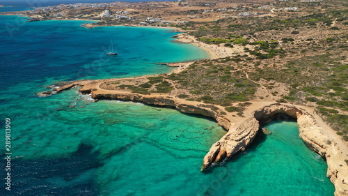 Aerial drone photo of paradise rocky seascape forming caves with turquoise clear sea near popular beaches of Pori and Italida, Koufonisi island, Cyclades, Greece