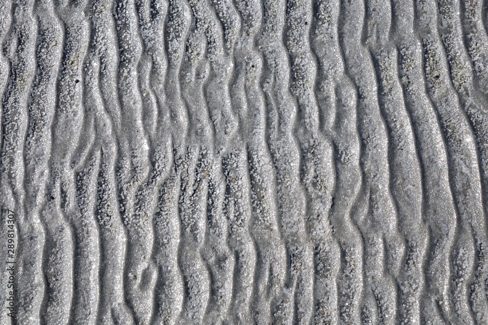 salty sand dunes on the shore of a salt lake