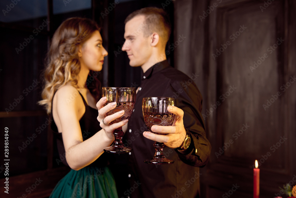 Young people dressed as vampires drinking cocktails at Halloween party