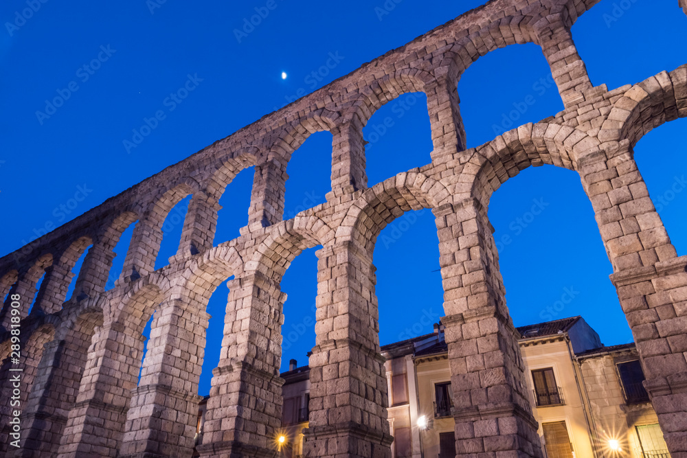 Partial view of the Roman aqueduct located in the city of Segovia at night , Unesco World Heritage Site, Spain Partial view of the Roman aqueduct located in the city of Segovia at night , Unesco World Heritage Site, Spain