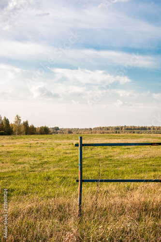 rural landscape with fence and blue sky