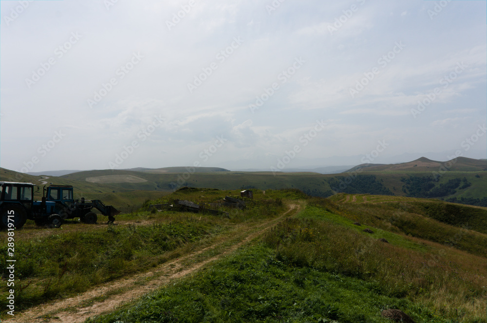 Fototapeta premium Lush green lawns meadows and mountains above 2000 m on the gumbashi pass in the northern caucasus between dombay and kislowodsk, raw original picture
