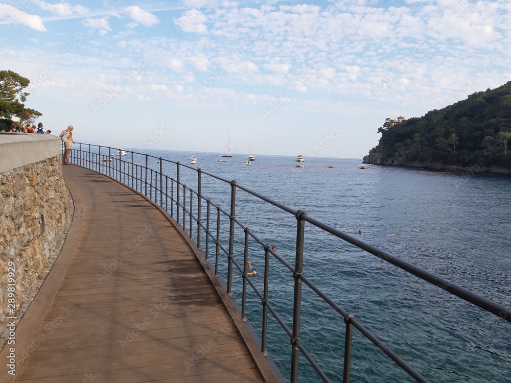 Portofino, Italy - 08/29/2019: Beautiful bay with colorful houses in Portofino in sumer days. Hiking around the ligurian mountains with amazing panoramic view. Portofino, Italy - 08/29/2019: Beautiful bay with colorful houses in Portofino in sumer days. Hiking around the ligurian mountains with amazing panoramic view.