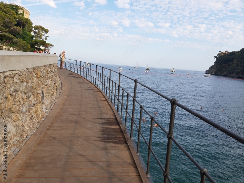 Portofino, Italy - 08/29/2019: Beautiful bay with colorful houses in Portofino in sumer days. Hiking around the ligurian mountains with amazing panoramic view.