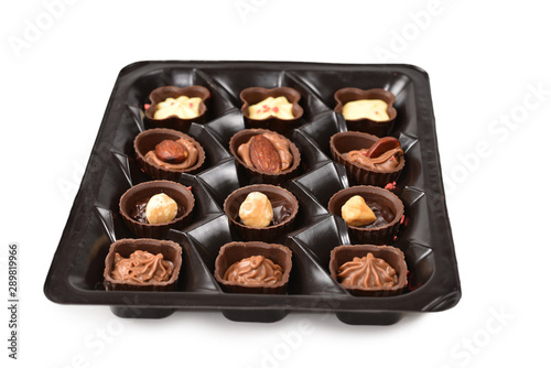 Chocolate candy collection in plastic box.