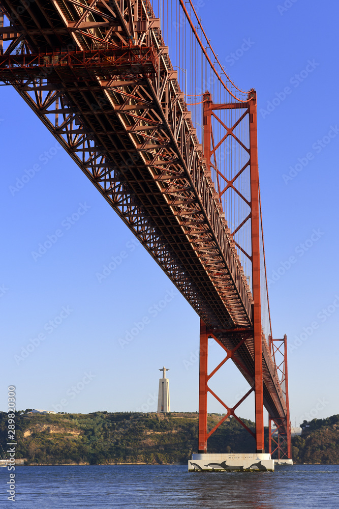The April 25 Bridge links central Lisbon with the south bank of the Tagus River, the monument of Cristo Rei overlooks the river from a towering pedestal on the south bank, Portugal