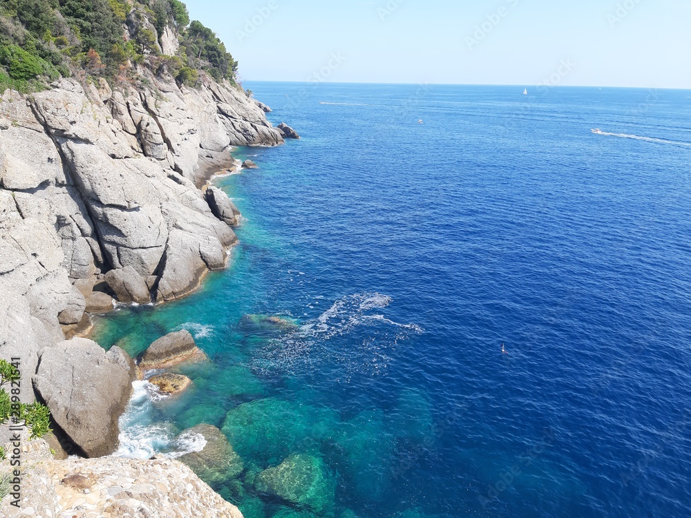 Portofino, Italy - 08/29/2019: Beautiful bay with colorful houses in Portofino in sumer days. Hiking around the ligurian mountains with amazing panoramic view. Portofino, Italy - 08/29/2019: Beautiful bay with colorful houses in Portofino in sumer days. Hiking around the ligurian mountains with amazing panoramic view.