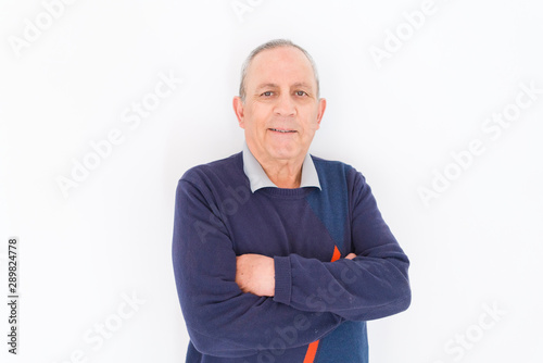 Handsome middle age senior man smiling cheerful, happy and positive leaning over white background with crossed arms