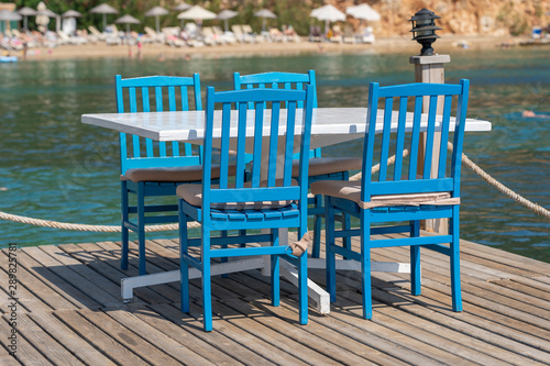 Table and chairs in beach cafe near sea water  Bodrum  Turkey. Beach cafe near sea  outdoors