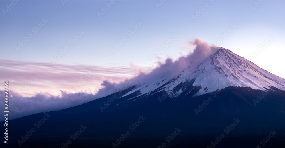 Fuji volcano mountain coverd with snow and cloud in sunset.