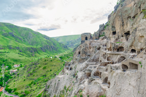 View of the cave city Vardzia. View from the cave city to the river valley and green slopes on a Sunny summer day
