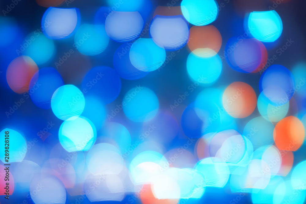Fototapeta premium Abstract blue bokeh lights background. Blurred colored lights garlands. Beautiful Christmas and New Year background.