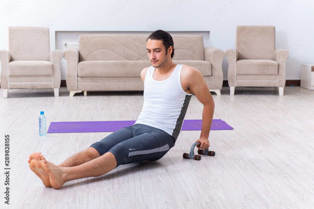 Young man training and exercising at home