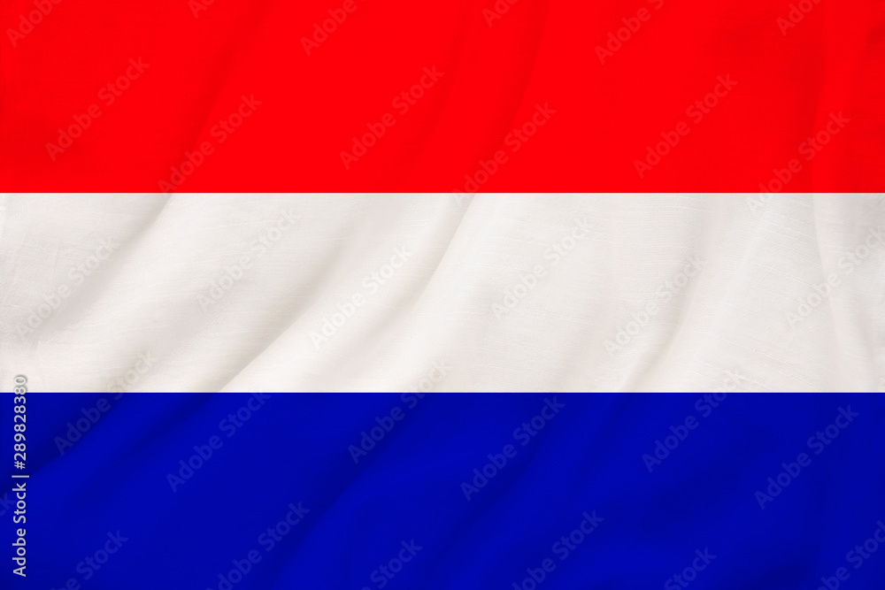 Naklejka premium national flag of the country Holland on gentle silk with wind folds, travel concept, immigration, politics, copy space, close-up
