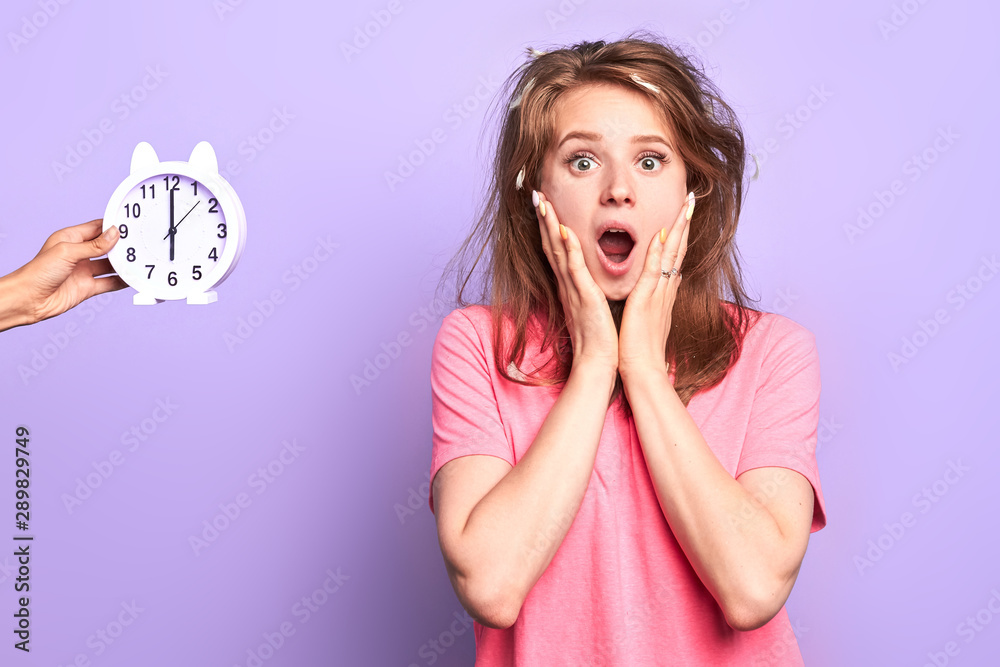 Emotional dark blonde young female being in panic, overslept important work meeting, frustrated and stressed, holding her face with both hands, eyes and mouth wide opened, posing indoors. Emotional dark blonde young female being in panic, overslept important work meeting, frustrated and stressed, holding her face with both hands, eyes and mouth wide opened, posing indoors.