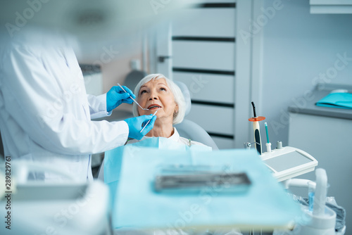 Ault woman ishaving a checkup at the dentist