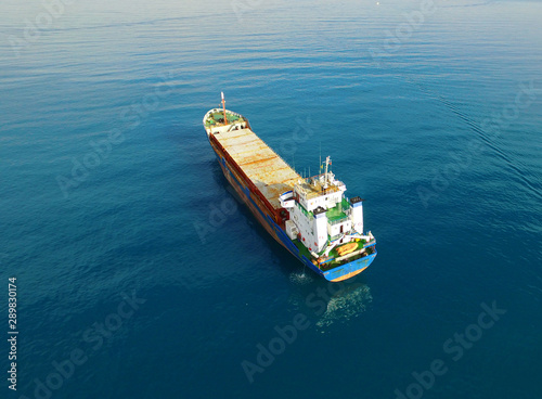 cargo container ship traveling in water | High Level Bird Eye Shot