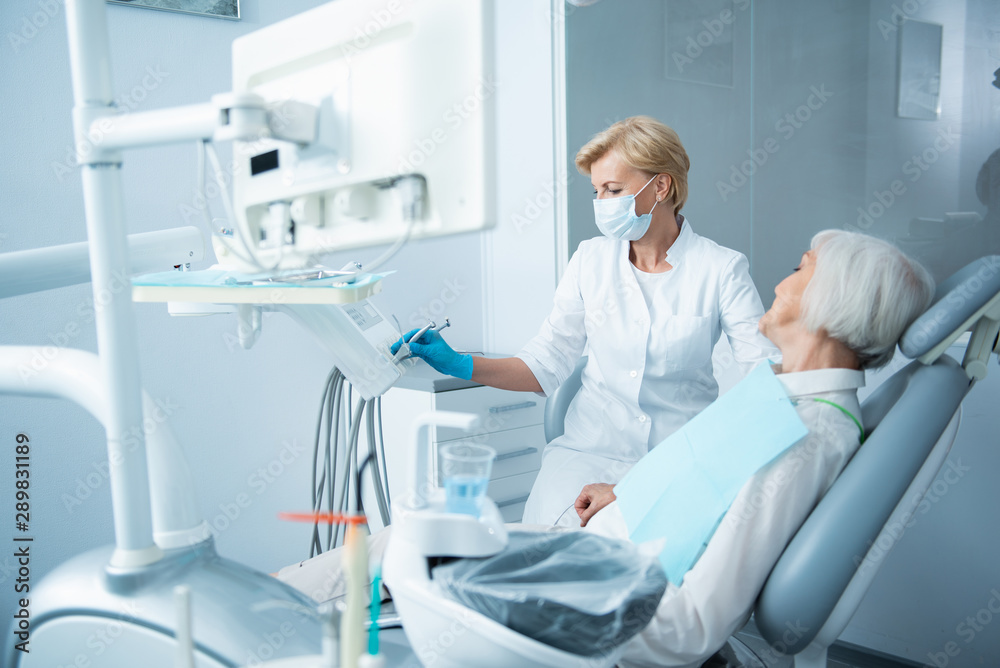 Smiling lady with closed eyes lying in dental chair