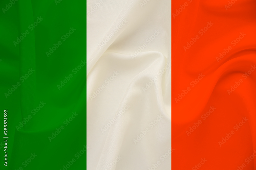 Obraz premium national flag of the country ireland on delicate silk with wind folds, travel concept, immigration, politics, copy space, close-up