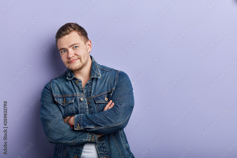 good looking muscular man crossing his arms , posing the camera, close up portrait, isolated blue background, studio shot . copy space good looking muscular man crossing his arms , posing the camera, close up portrait, isolated blue background, studio shot . copy space