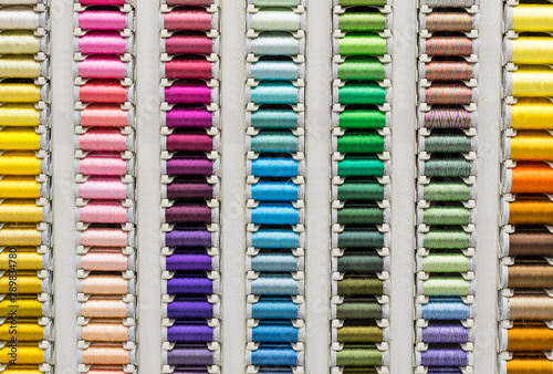 Sale of threads for sewing. Large selection of colors. Atelier, handwork, fabric and sewing accessories store. Background, texture.