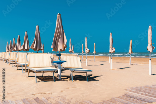 Beach in late summer, deck chairs and parasols © Allusioni