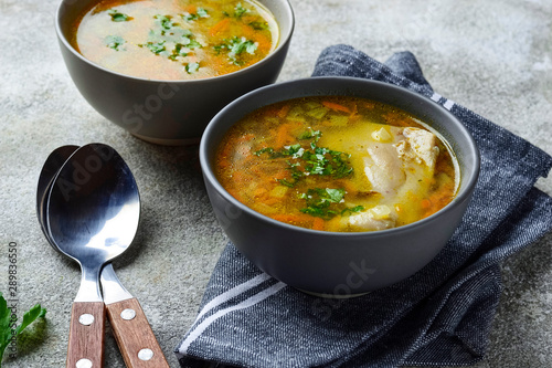 Chicken broth or soup with vegetable photo