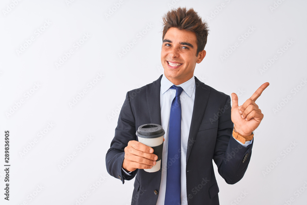 Young handsome businessman wearing suit holding coffee over isolated white background very happy pointing with hand and finger to the side Young handsome businessman wearing suit holding coffee over isolated white background very happy pointing with hand and finger to the side