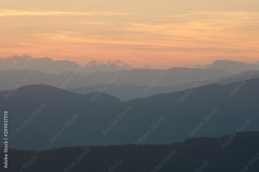 Peaceful nature landscape background with mountains on sunset
