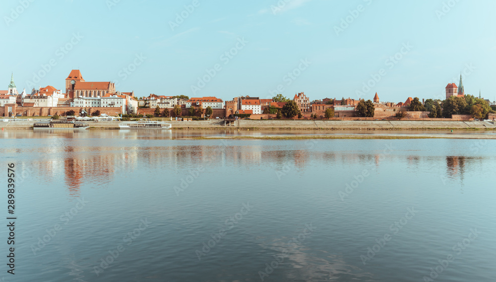 Torun.  View from behind the Vistula River to the old medieval city walls and architecture. Poland