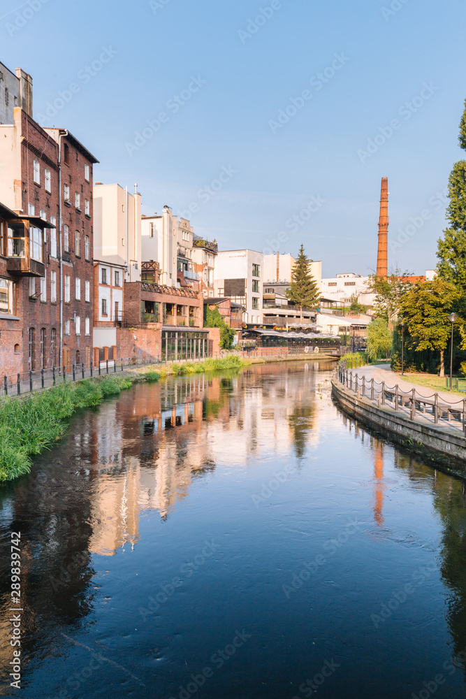 Bydgoszcz in Poland.  Picturesque channels of the Brda River flowing through the city center.  Old historic factory and residential buildings stand along the river