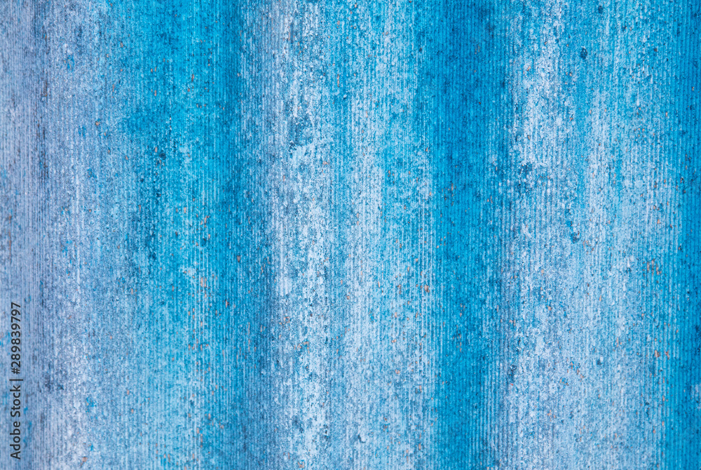 The wall is painted with blue paint as an abstract background