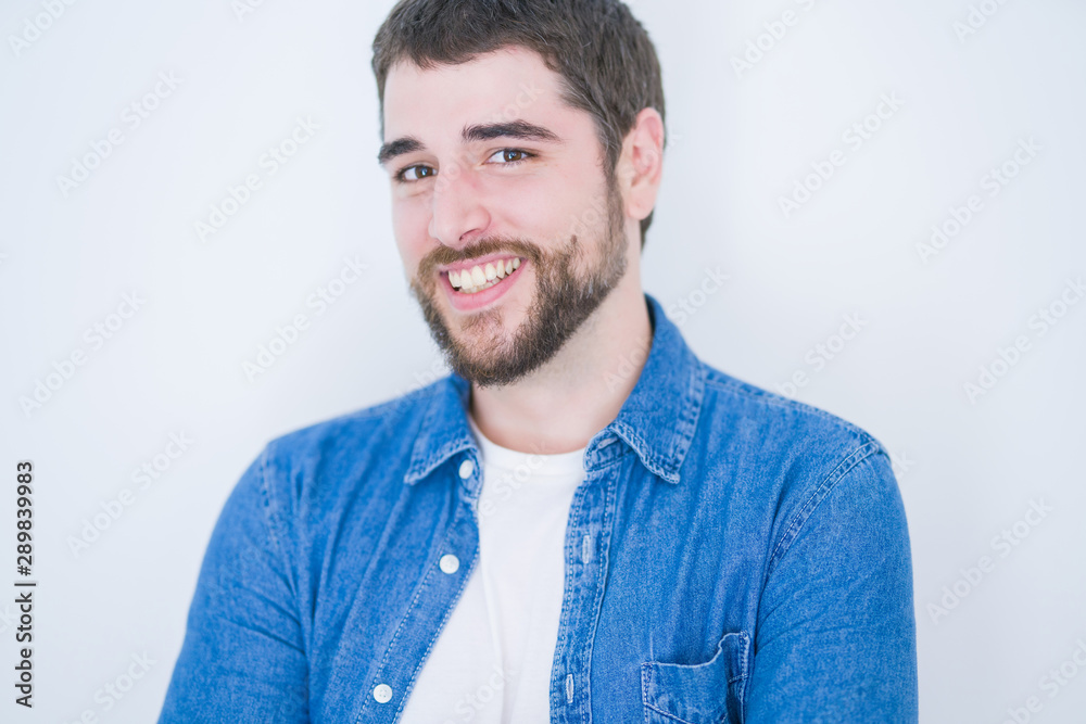 Young handsome hispanic man smiling at the camera looking happy and confident over isolated white background Young handsome hispanic man smiling at the camera looking happy and confident over isolated white background