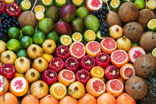 Background of fresh fruit in the market. Orange pomegranate grape lime coconut mango grapefruit.