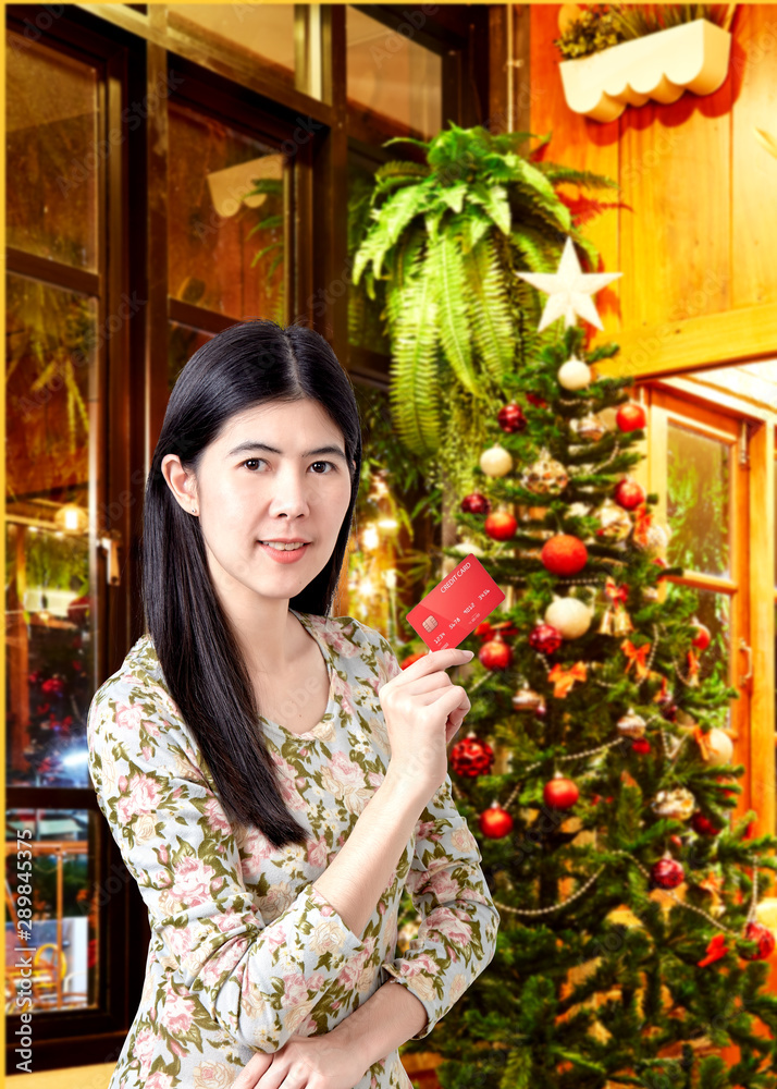 Woman holding credit card for making payment Woman holding credit card for making payment