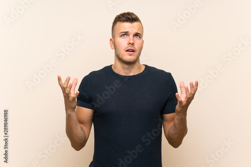 Young handsome blonde man over isolated background frustrated by a bad situation